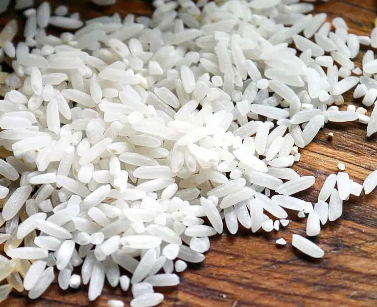 White rice on wooden cutting board